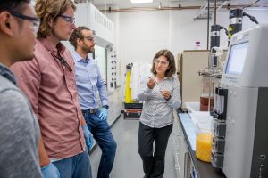 31932D, CRI innovators lab: Chain Reaction Innovation entreprenuers Justin Whiteley and Tyler Huggins work with Argonne scientist Meltem Urgun-Demirtas in an Energy Systems Division laboratory to grow tunable, high-performance porous carbon from fungi. (Sokamrint Chak, post-doc)
